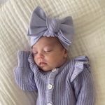 baby wearing the one size lavender bow