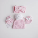pink knitted booties with warm white frill  at the top of booties. pink bootie lace which can be tied into a bow to secure booties on to baby's foot