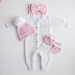 pink knitted booties with warm white frill  at the top of booties. pink bootie lace which can be tied into a bow to secure booties on to baby's foot