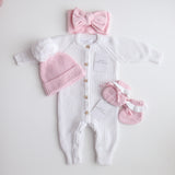 pink knitted booties with warm white frill  at the top of booties. pink bootie lace which can be tied into a bow to secure booties on to baby's foot