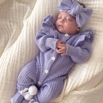 Frilly Lavender Romper baby wearing the outfit with a bow