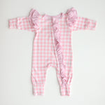 flatlay pink gingham frilly onesie