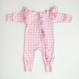 flatlay pink gingham frilly onesie