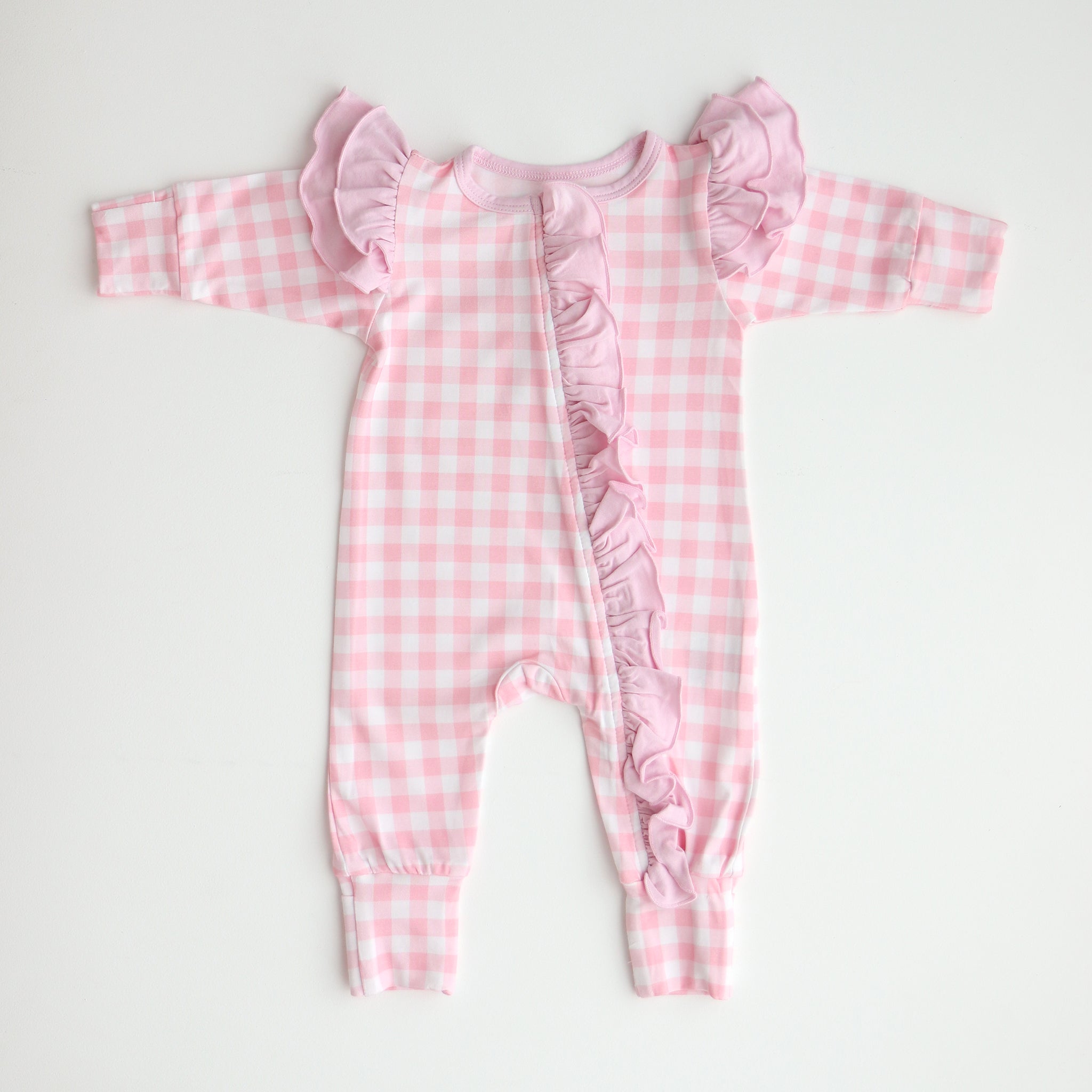 flatlay pink gingham frilly onesie