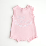 our pretty pink hello world has scalloped edges on short sleeve for arms and delicate knitted frill on legs. At the crotch and down the centre and on shoulder we have added white resin flower buttons. Matches with our bonnet booties beanie and other pretty pink items. Hello world type in the centre is white surrounded by delicate flowers. The type is in running writing with capital letters at the start - beautiful for baby girl