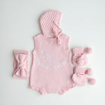 our pretty pink hello world has scalloped edges on short sleeve for arms and delicate knitted frill on legs. At the crotch and down the centre and on shoulder we have added pink resin flower buttons. Matches with our bonnet booties beanie and other pretty pink items. Hello world type in the centre is white surrounded by delicate flowers. The type is in running writing with capital letters at the start - beautiful for baby girl