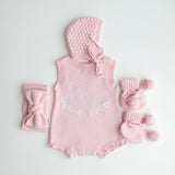 our pretty pink hello world has scalloped edges on short sleeve for arms and delicate knitted frill on legs. At the crotch and down the centre and on shoulder we have added pink resin flower buttons. Matches with our bonnet booties beanie and other pretty pink items. Hello world type in the centre is white surrounded by delicate flowers. The type is in running writing with capital letters at the start - beautiful for baby girl