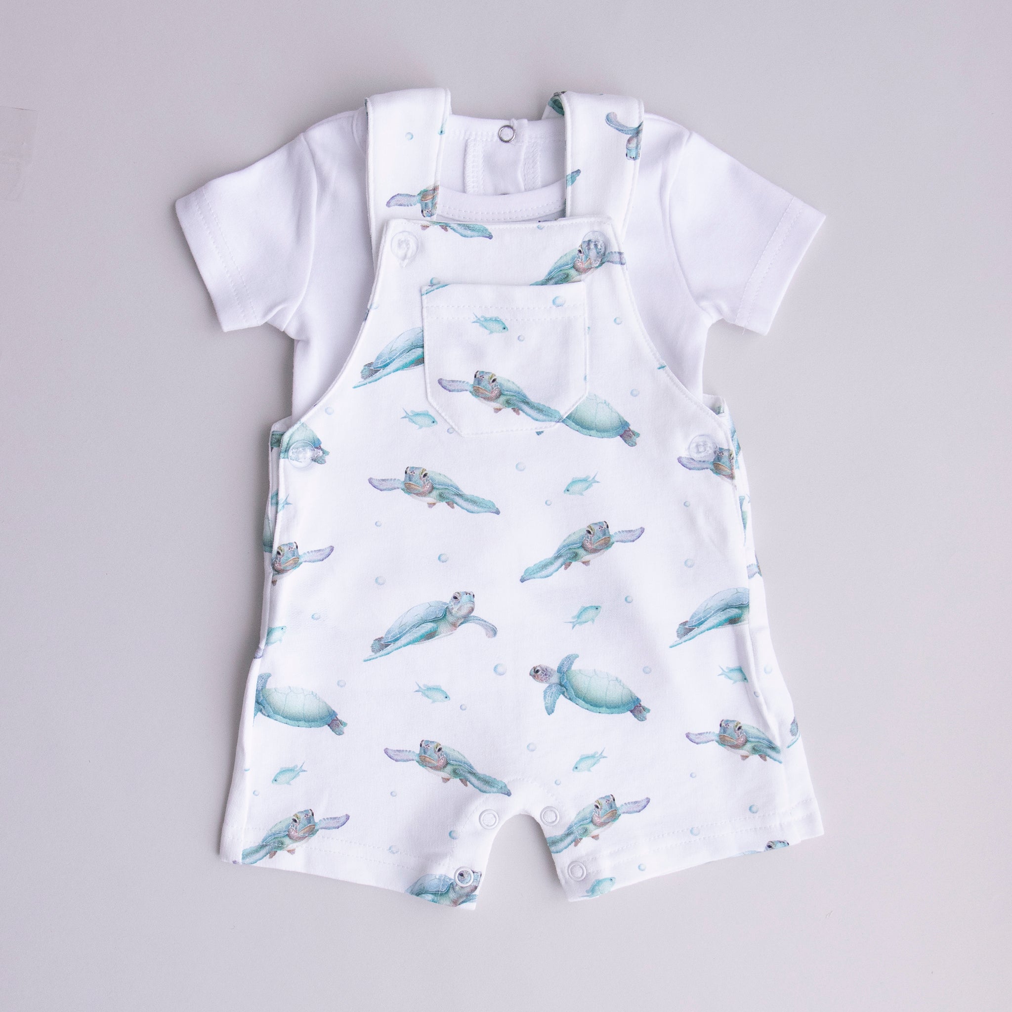 white t-shirt matched with ocean turtle overalls