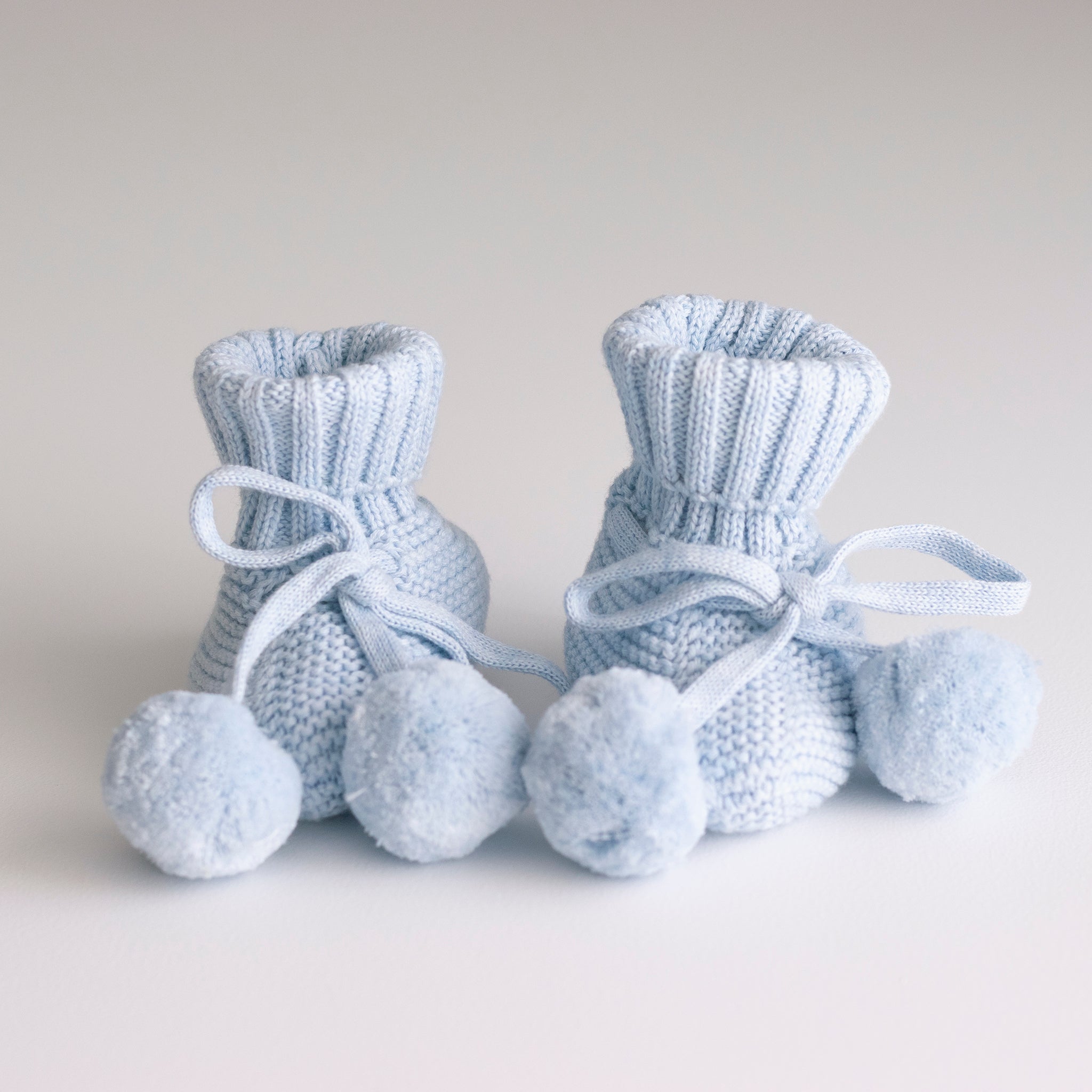 Knitted Baby Booties With Pom Poms