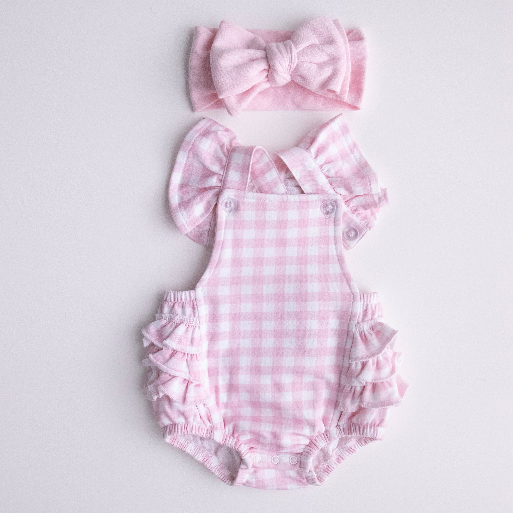pretty pink gingham playsuit with pretty pink jacquard knit bow
