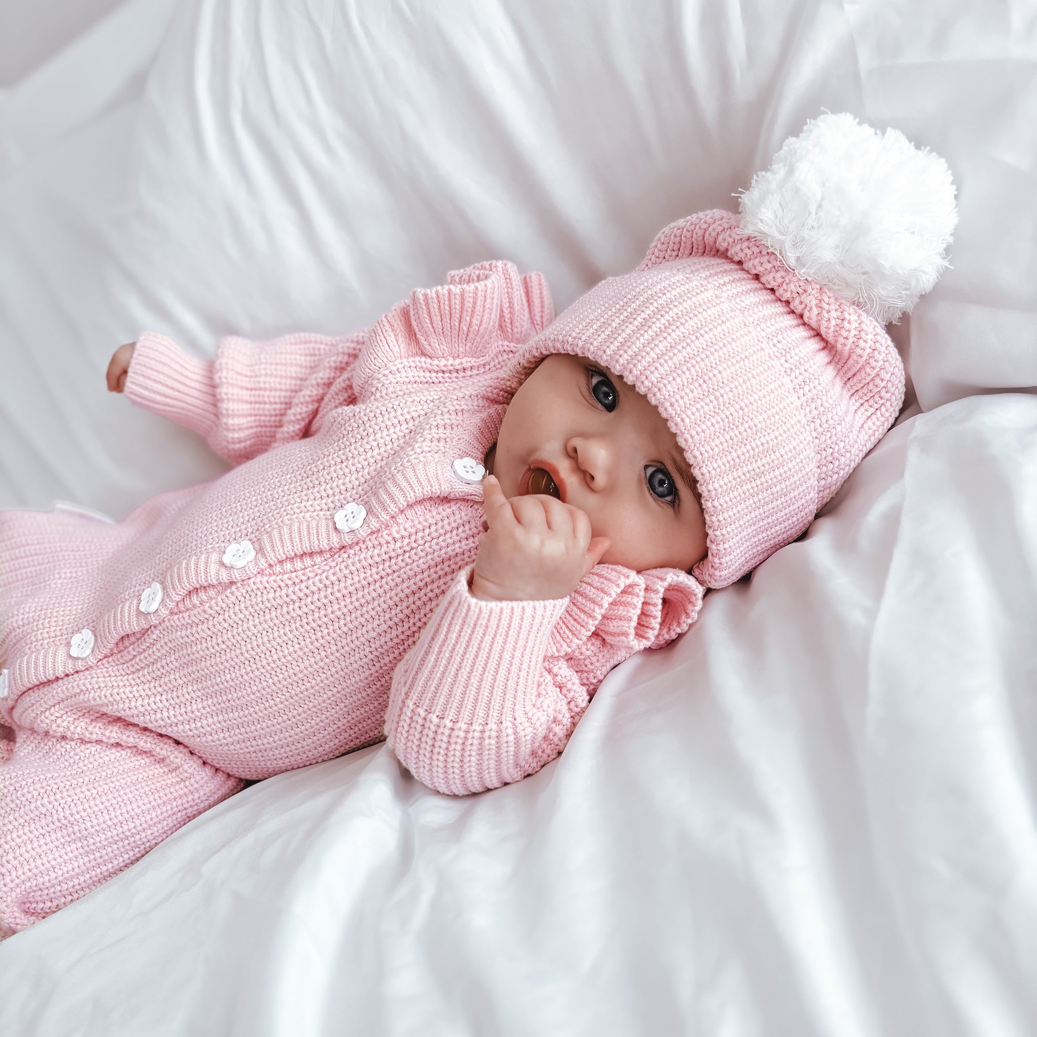 frilly-pretty-pink-romper-with matching beanie with white pom pom to natch white flower buttons