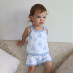 cotton knitted shorts with blue boat pattern on white background. Blue trims and blue elastic waist with drawstring. Waist band is 4 cm high and the leg trim is 1.5 cm high