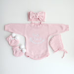 cute pom pom booties - booties are pink with warm white pom pom and warm white lace tied in bow to secure booties