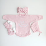 cute pom pom booties - booties are pink with warm white pom pom and warm white lace tied in bow to secure booties