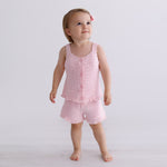 pink knitted short sleeve singlet top. eyelet wave pattern light weight frill on hem, Young girl 3 years old wearing top & shorts
