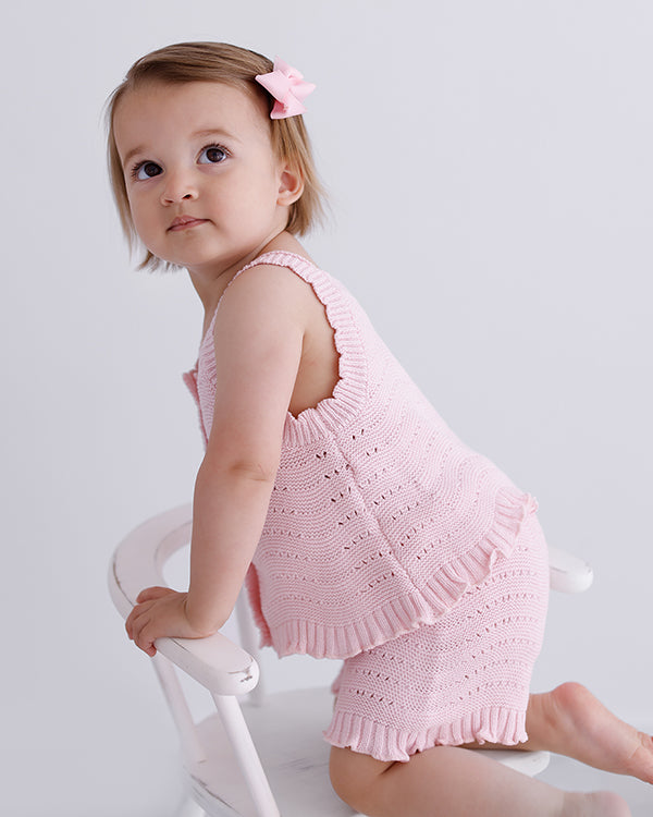 pink knitted short sleeve singlet top. eyelet wave pattern light weight frill on hem, Young girl 3 years old wearing top & shorts 