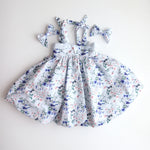 Floral dress with matching headbands on a light gray backgroun