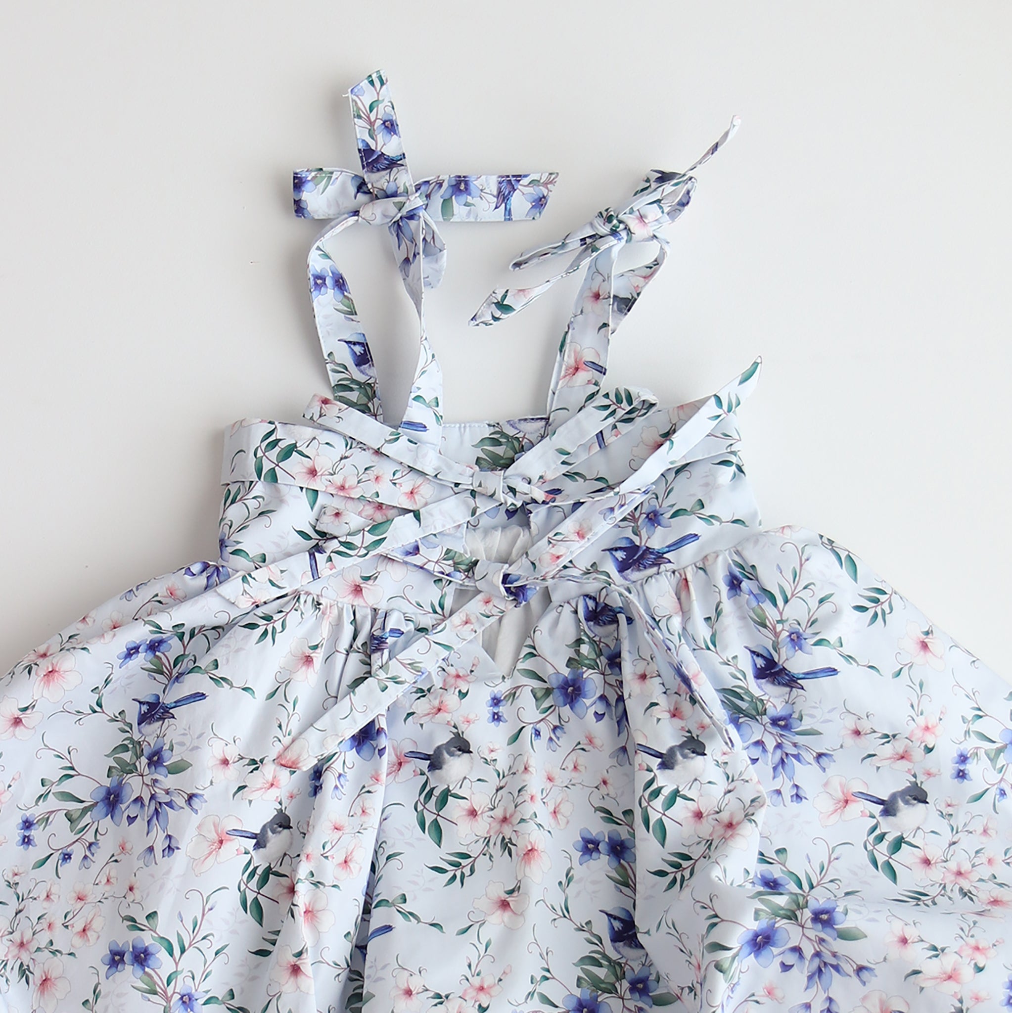 Floral dress with ribbon straps on a light background