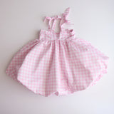 Pink gingham dress on a white background