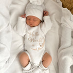 heirloom romper newborn koala hello world and matching warm white booties and bow, the embroidery is a milky coffee coloured yarn but looks slightly golden. It is perfect as a newborn gift. Koala sleeping with the cutest face matching the baby's cutest sleeping face x