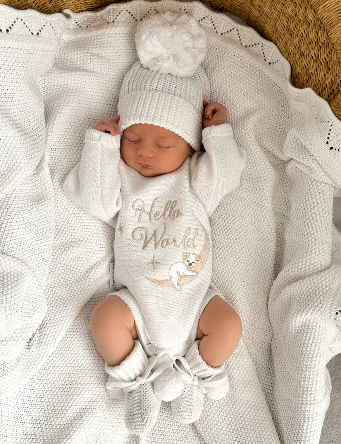 heirloom romper newborn koala hello world and matching warm white booties and bow, the embroidery is a milky coffee coloured yarn but looks slightly golden. It is perfect as a newborn gift. Koala sleeping with the cutest face matching the baby's cutest sleeping face x