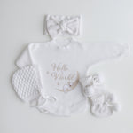 Koala hello world romper flatlay with matching warm white jacquard knit bow bonnet and booties - perfect for newborn gift