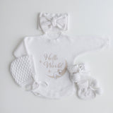 Koala hello world romper flatlay with matching warm white jacquard knit bow bonnet and booties - perfect for newborn gift