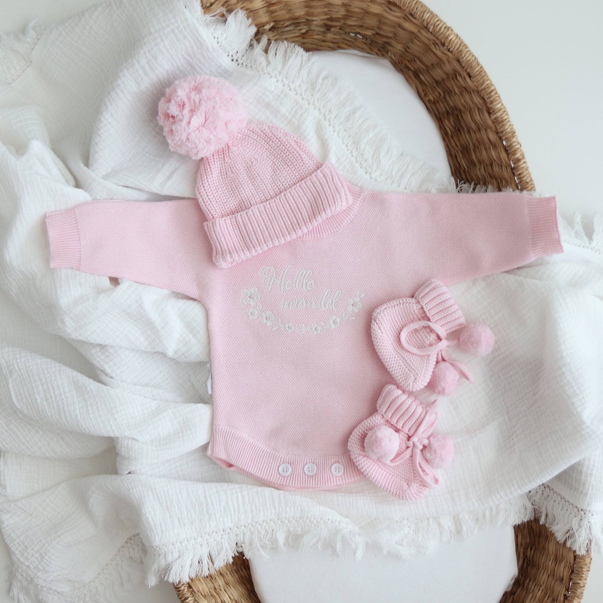 heirloom romper pretty pink hello world clearance white embroidery text hello world with flowers in a circle underneath flowers 5 petals and pink centre 