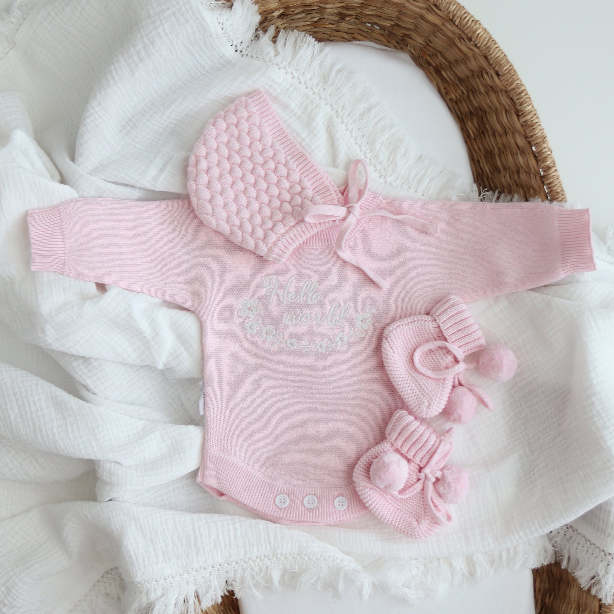 heirloom romper pretty pink hello world clearance white embroidery text hello world with flowers in a circle underneath flowers 5 petals and pink centre 