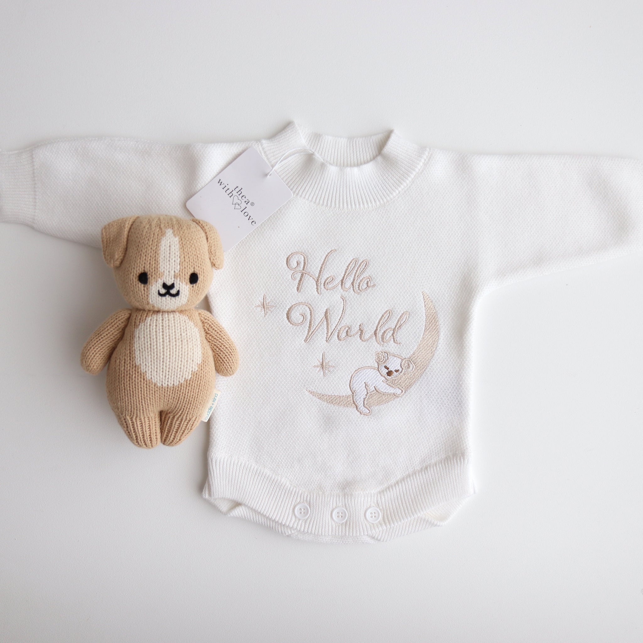 Flatlay of the Hello World Koala romper showing the embroidery imperfection — the koala’s face appears untidy with a slightly larger nose.