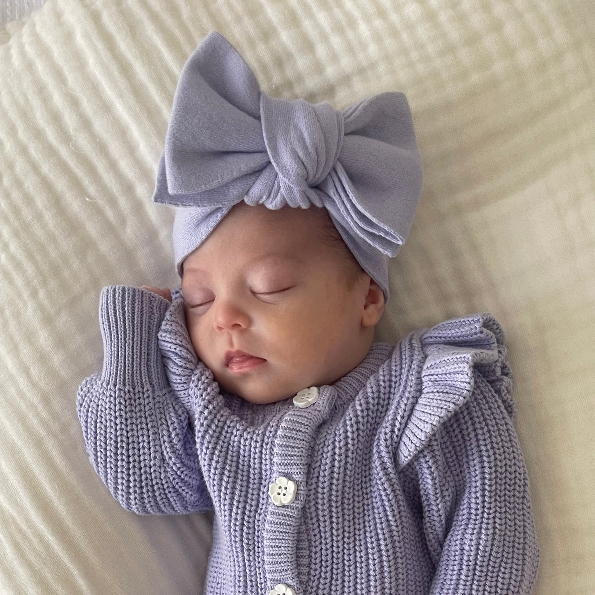 baby wearing the one size lavender bow