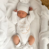 heirloom romper newborn koala hello world and matching warm white booties and bow, the embroidery is a milky coffee coloured yarn but looks slightly golden. It is perfect as a newborn gift. Koala sleeping with the cutest face matching the baby's cutest sleeping face x