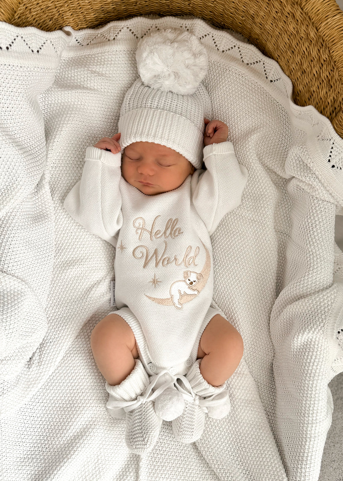 heirloom romper newborn koala hello world and matching warm white booties and bow, the embroidery is a milky coffee coloured yarn but looks slightly golden. It is perfect as a newborn gift. Koala sleeping with the cutest face matching the baby's cutest sleeping face x