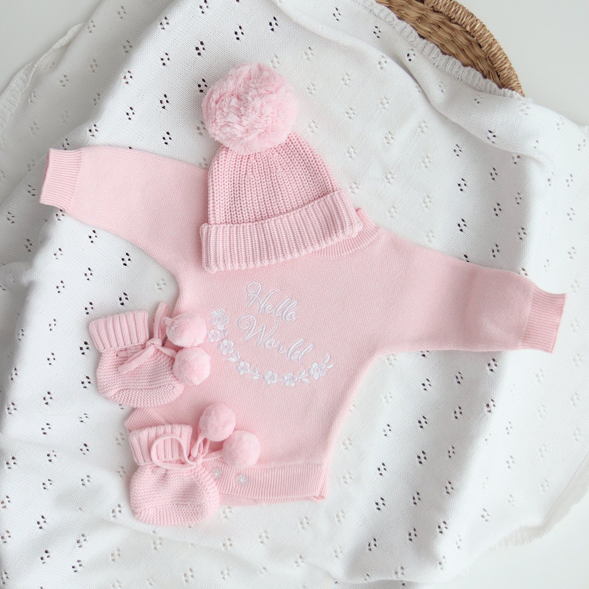 Pink Hello World knit romper with matching pom pom beanie and booties