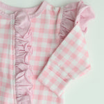 close up photo showing detail with the very neat over locking sewing on the edge of the frill