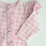 close up photo showing detail with the very neat over locking sewing on the edge of the frill