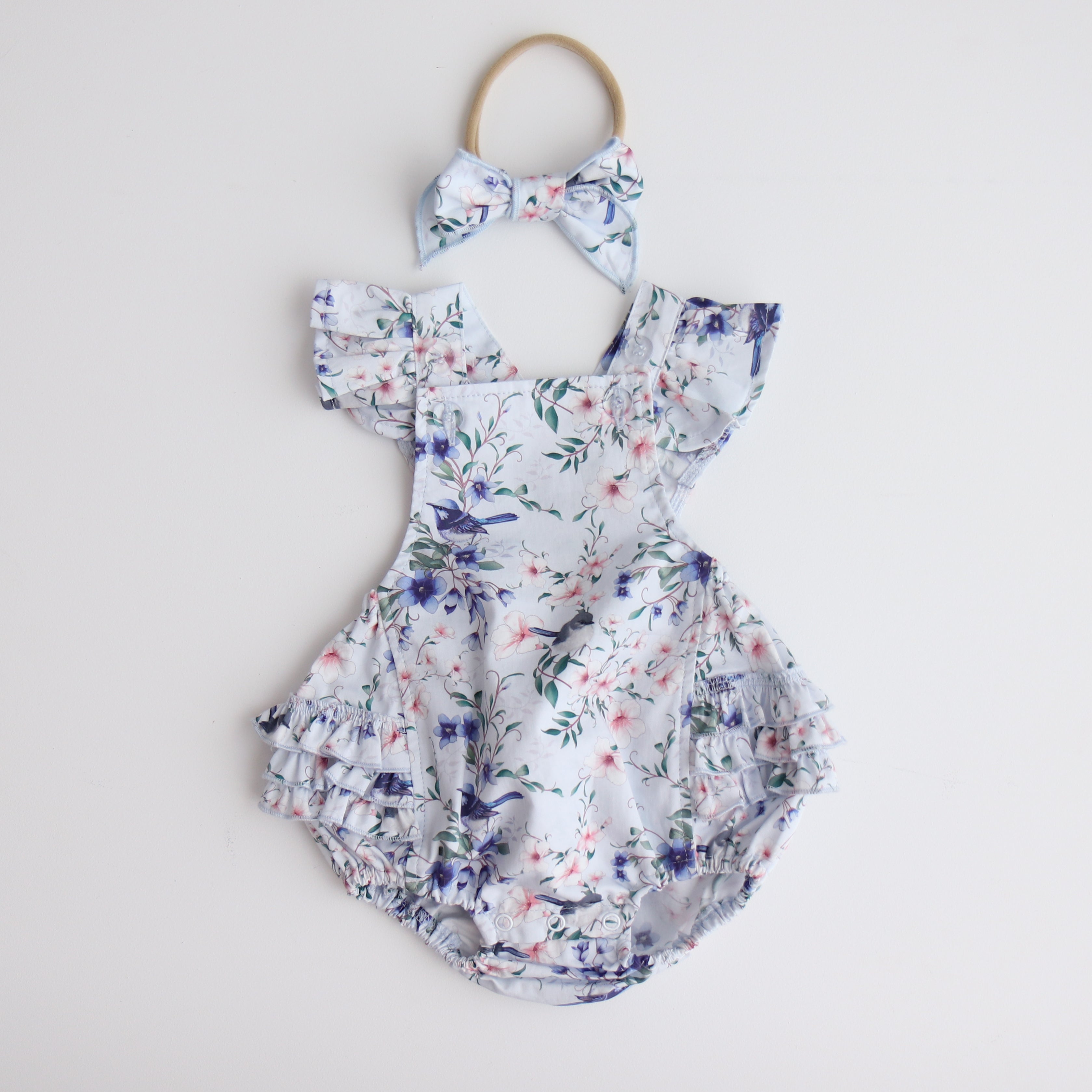Playsuit - Blue Fairy Wren with bow on white background as a flat lay