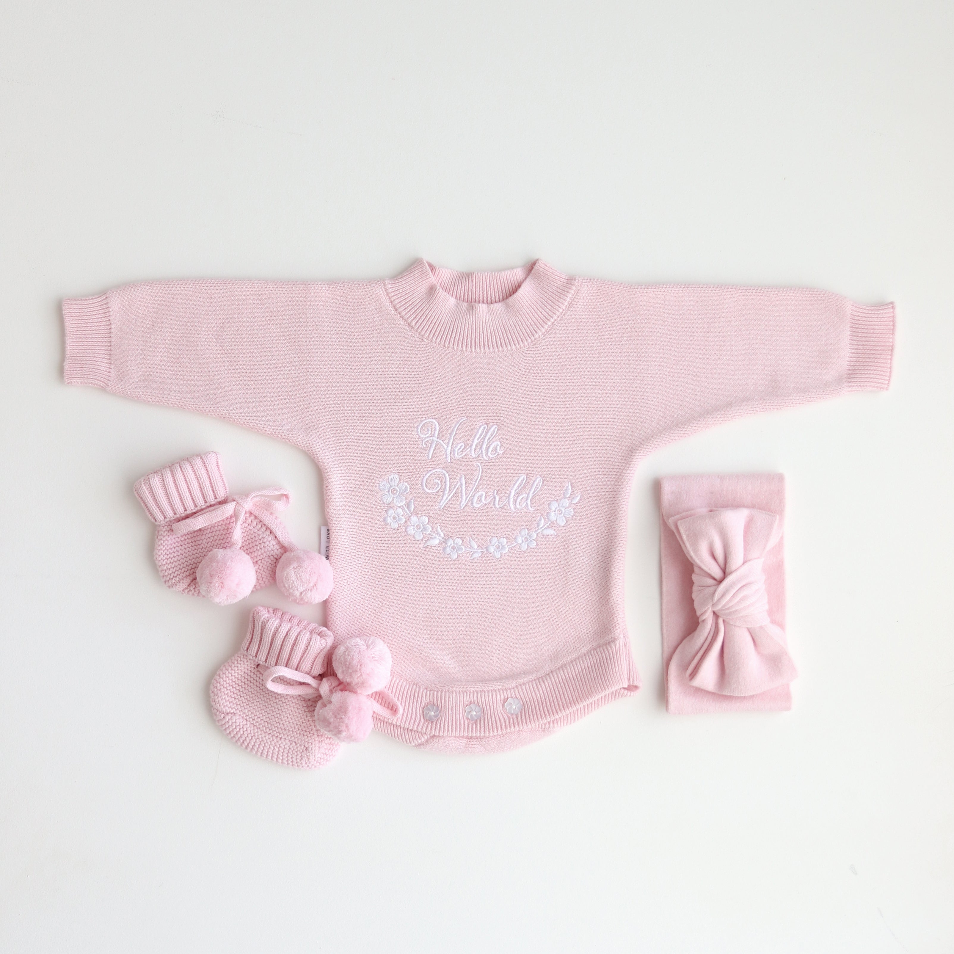 Pretty Pink Hello World Bundle With Bow. The embroidery hello world is in white yarn and it is placed in the centre of romper chest area so it is clearly seen in your announcement photos match with bow and booties