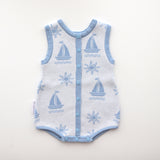 blue trim leg neck sleeves and centre trim also blue with blue snap buttons and snap buttons on crotch, sun and boat pattern on white background