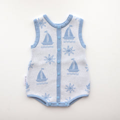 blue trim leg neck sleeves and centre trim also blue with blue snap buttons and snap buttons on crotch, sun and boat pattern on white background