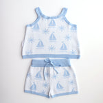 cotton knitted shorts with blue boat pattern on white background. Blue trims and blue elastic waist with drawstring. Waist band is 4 cm high and the leg trim is 1.5 cm high