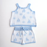 cotton knitted shorts with blue boat pattern on white background. Blue trims and blue elastic waist with drawstring. Waist band is 4 cm high and the leg trim is 1.5 cm high