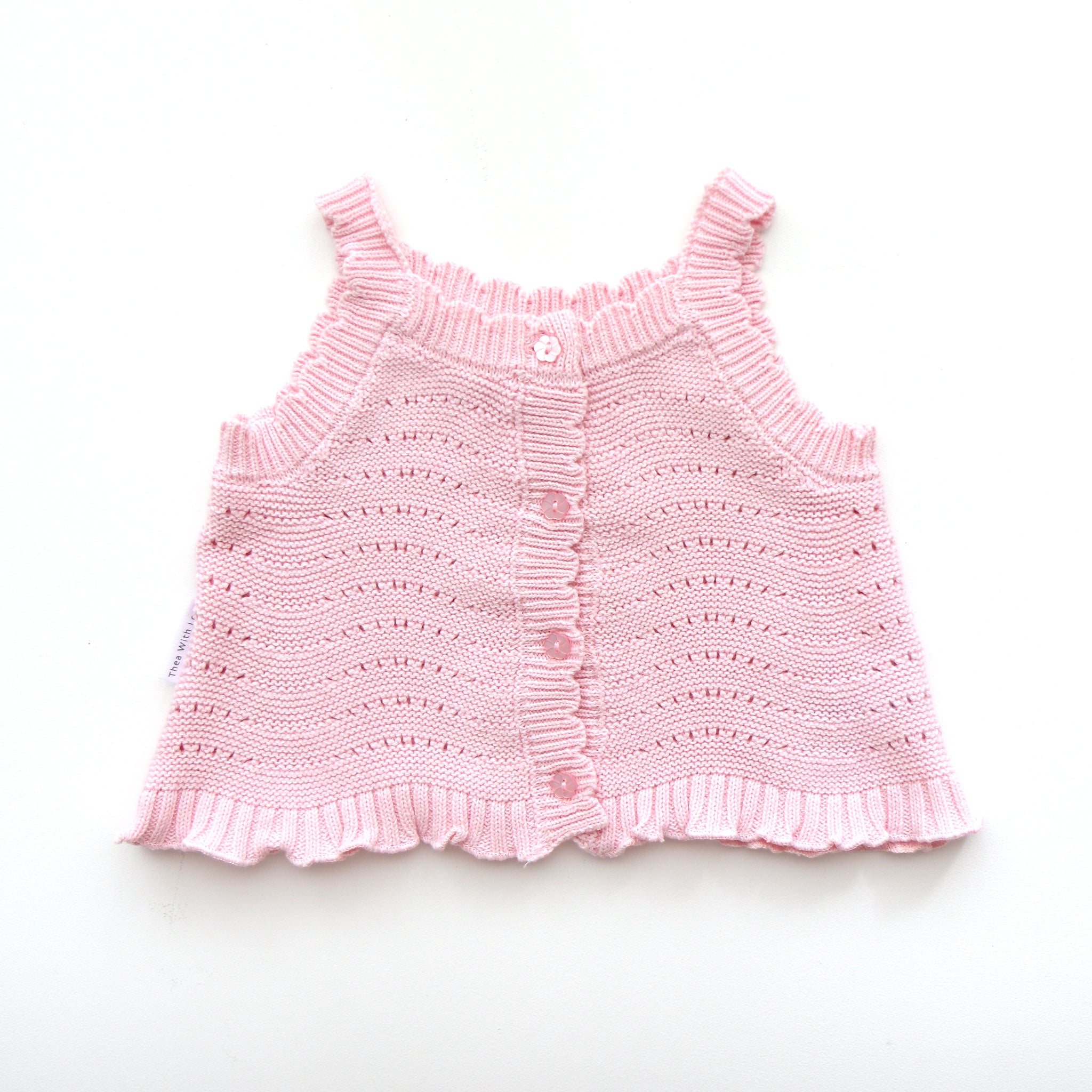 pink knitted short sleeve singlet top. eyelet wave pattern light weight frill on hem