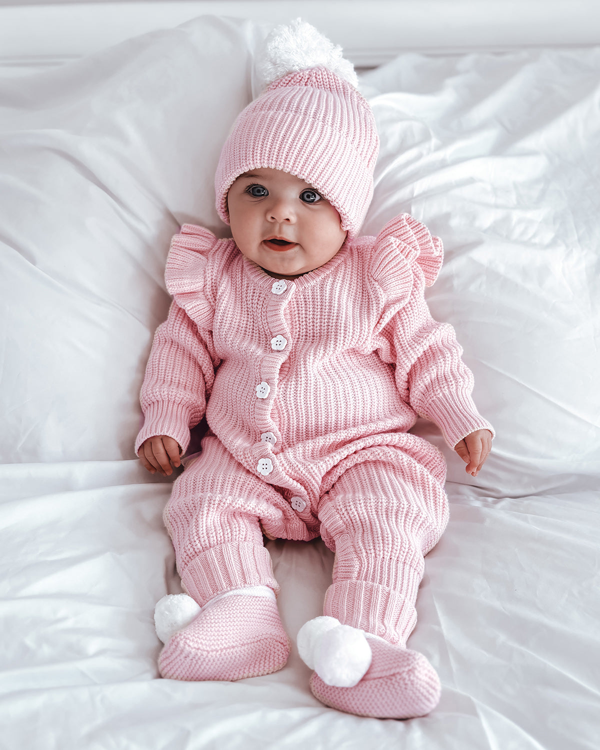 frilly-pretty-pink-romper-baby girl 5 months old with matching cute booties and beanie