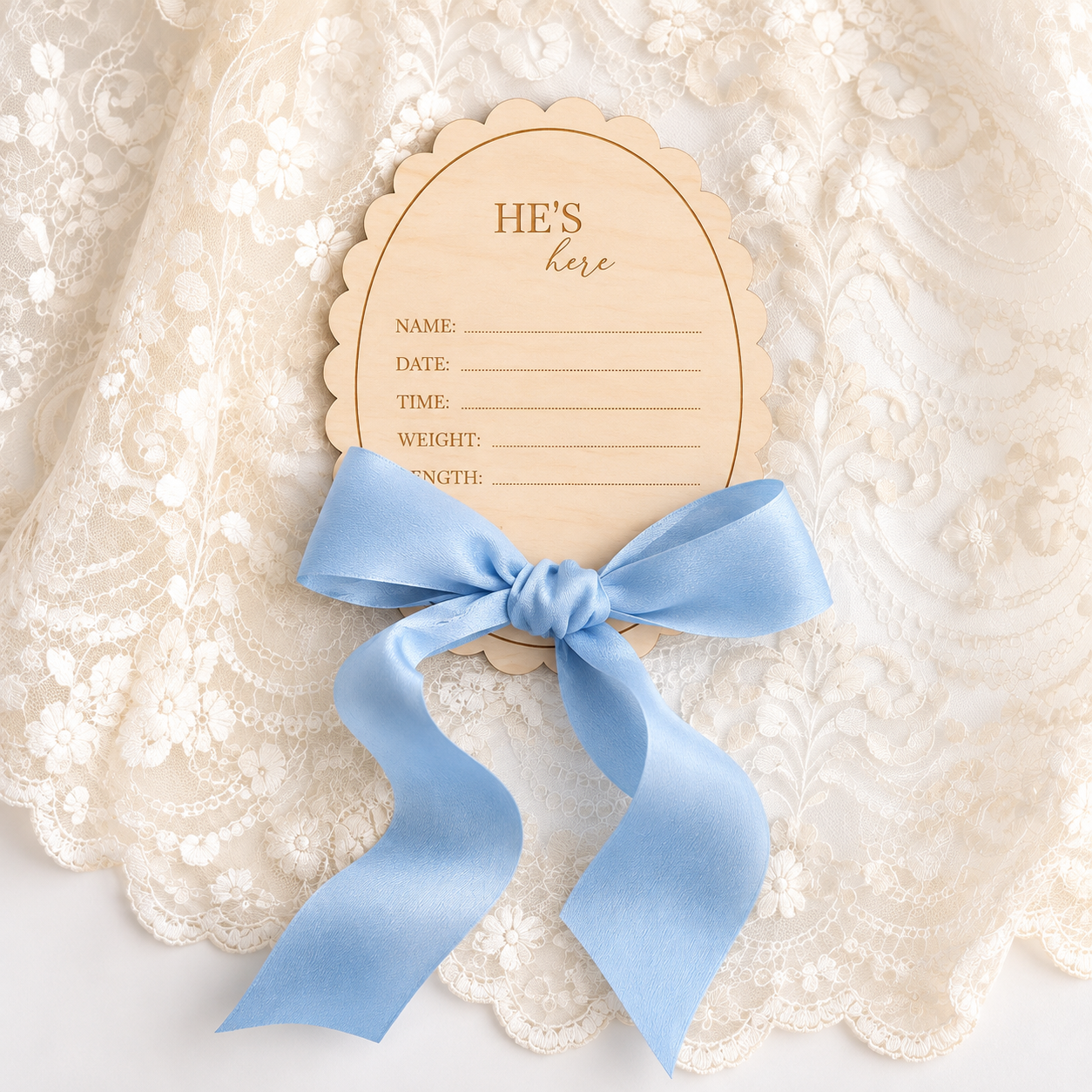 He's Here baby boy birth announcement disc with blue ribbon, made in Australia from basswood