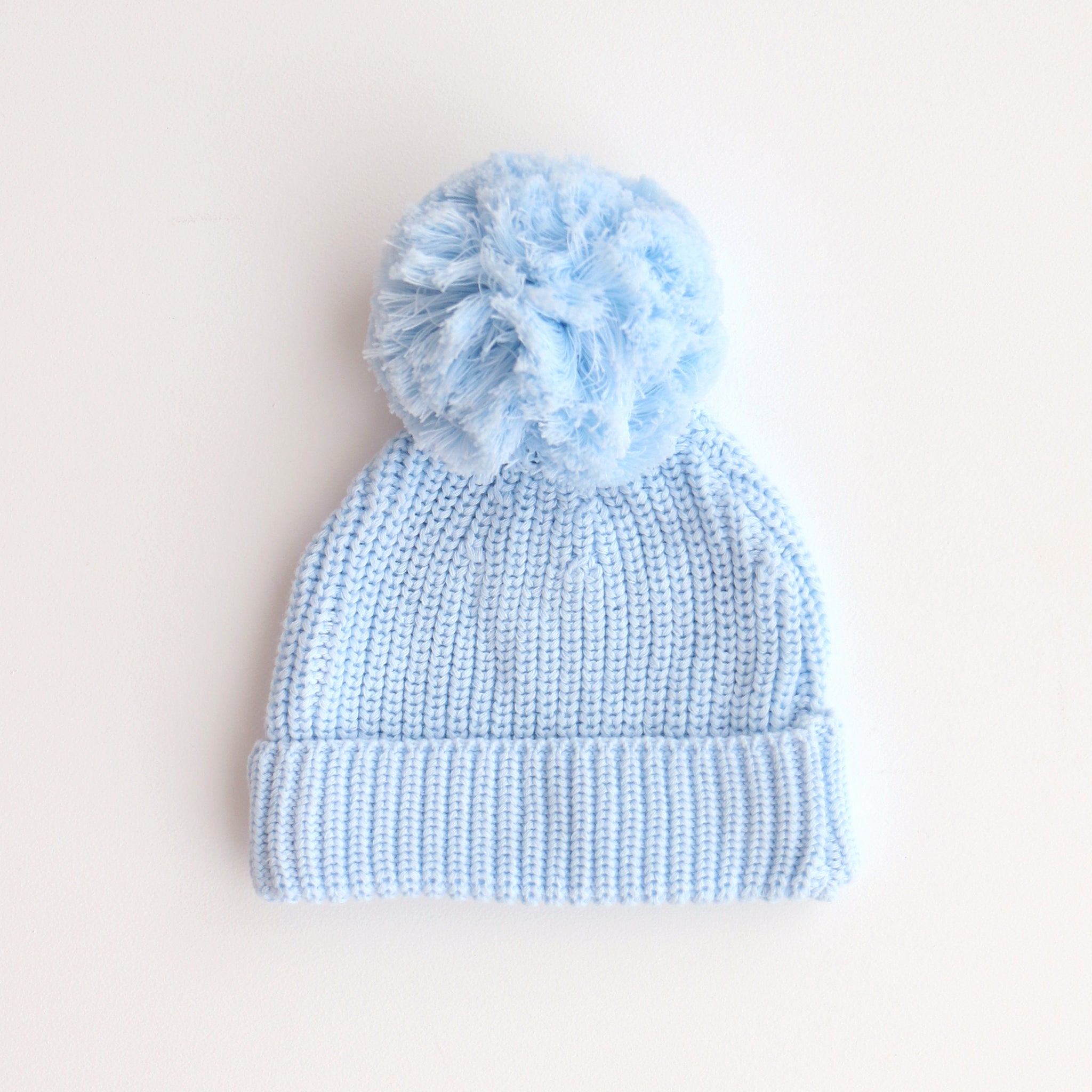 soft blue beanie with pom pom 