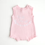 our pretty pink hello world has scalloped edges on short sleeve for arms and delicate knitted frill on legs. At the crotch and down the centre and on shoulder we have added white resin flower buttons. Matches with our bonnet booties beanie and other pretty pink items. Hello world type in the centre is white surrounded by delicate flowers. The type is in running writing with capital letters at the start - beautiful for baby girl 