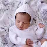 baby bonnet heirloom cotton knit in white colour matches the white romper. it is a keepsake for newborns