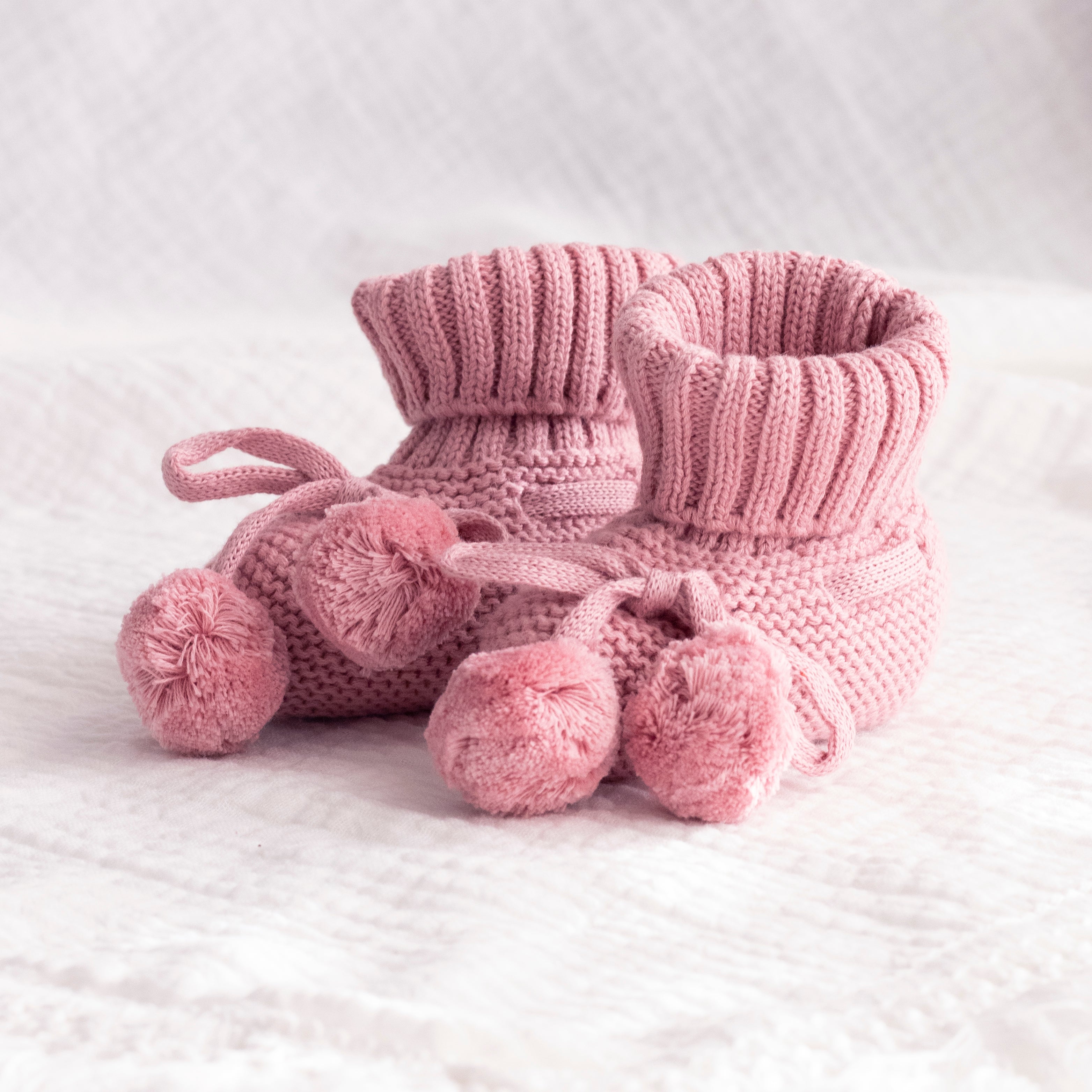 baby-booties-blush with pom poms