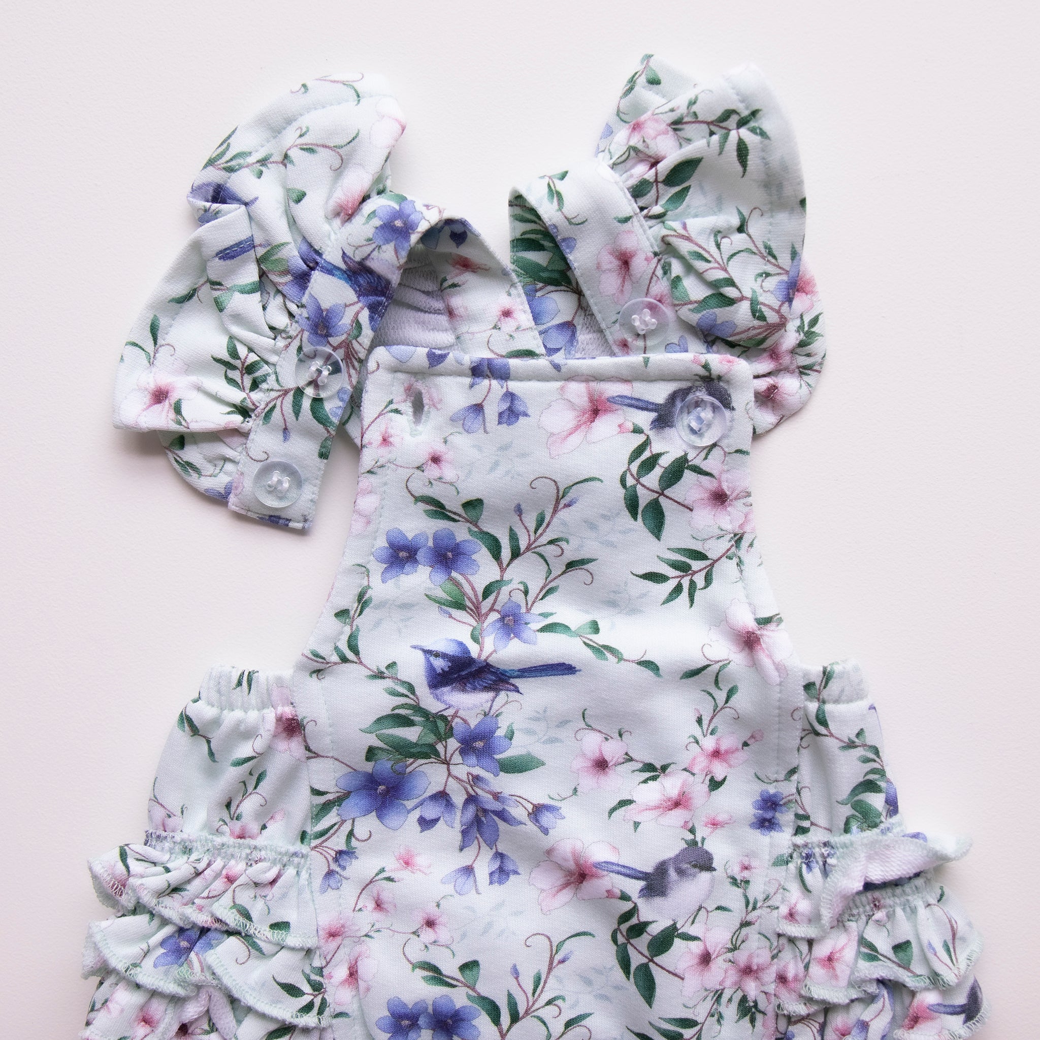 mint-fairy-wren-ruffle-playsuit-buttons- showing two on playsuit